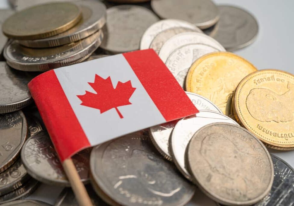 Canada flag on coins background, finance and accounting, banking concept