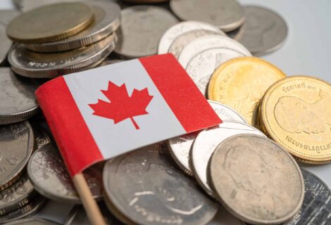 Canada flag on coins background, finance and accounting, banking concept